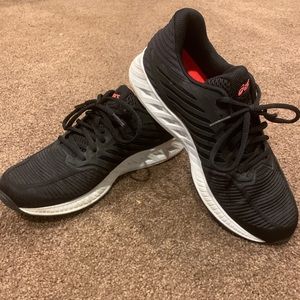 Black ASICS running shoes.